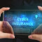 Person holding a transparent digital screen displaying the words “Cybersecurity Insurance,” symbolizing online security protection and risk management.
