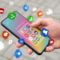 Person holding a smartphone with colorful social media app icons floating around, symbolizing digital communication, microsoft and online connectivity.