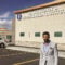 Professional standing outside the Idaho Kidney & Hypertension Institute, representing proactive IT support and technology solutions for healthcare organizations.