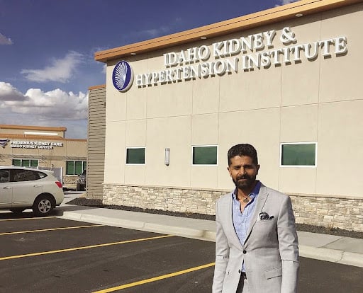 Professional standing outside the Idaho Kidney & Hypertension Institute, representing proactive IT support and technology solutions for healthcare organizations.