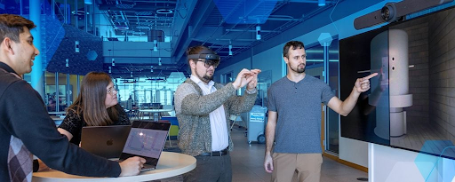 Group of people using augmented reality and digital collaboration tools in a modern tech workspace IT services.