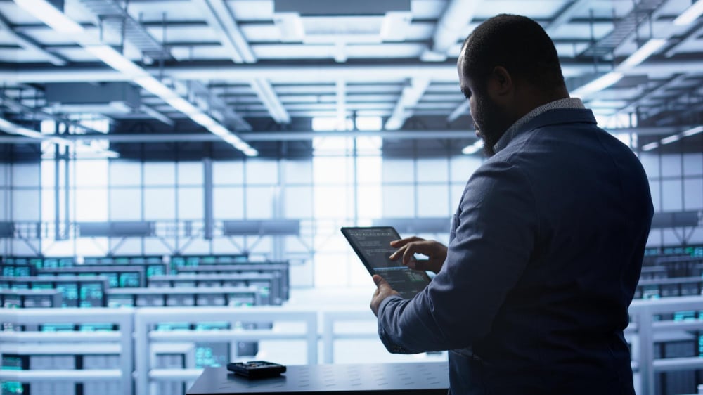 IT technician reviewing network map for managed IT services at a multi-site company